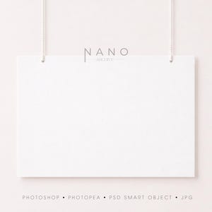 May include: A rectangular white sign hanging from two thin white strings. The text NANO ARCHIVE is printed in black above the sign. Below the sign, the text PHOTOSHOP • PHOTOPEA • PSD SMART OBJECT • JPG is printed in a small, simple black font.