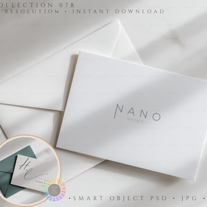 May include: A minimalist stationery set featuring a white card with the text "NANO ARCHIVE" and a matching envelope. A smaller card with a teal envelope and handwritten initials is also included. The image is set against a white background.