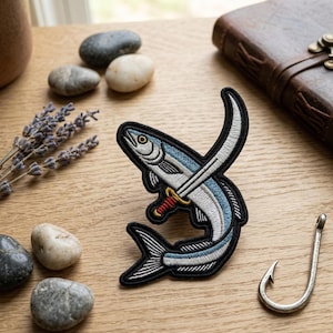 May include: Embroidered patch featuring a fish pierced by a sword. The fish has blue and white details with a black outline. The sword has a red and gold hilt. A silver fishing hook is also visible.