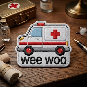 May include: A white ceramic mug with a black handle and the text "But First, Coffee" in a bold, black font. The mug is set against a neutral background, highlighting its simple design.