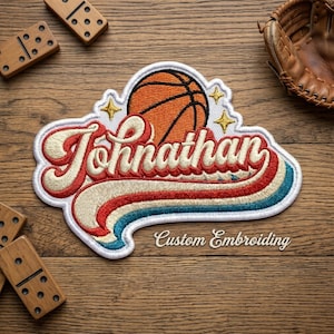May include: Embroidered patch featuring a basketball and the name "Jonathan" in a retro style. The patch has a white border, with red, cream, and blue stripes. The text "Custom Embroidery" is also included.