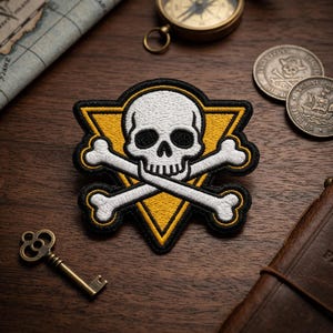 May include: Embroidered patch featuring a white skull and crossbones design set against a yellow triangle, outlined in black. The patch is a pirate-themed accessory. Additional items include a compass, coins, and a key.