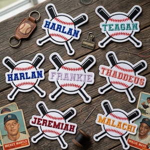 May include: Baseball-themed patches with names embroidered in various colors, including Harlan, Teagan, Frankie, Thaddeus, Jeremiah, and Malachi. Each patch features a baseball design with crossed bats. A leather baseball keychain and vintage baseball cards are also visible.