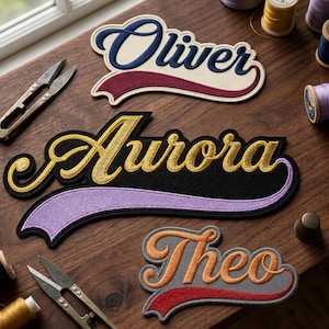 May include: Close-up of three embroidered name patches: "Oliver" in blue and burgundy, "Aurora" in gold and black, and "Theo" in orange and red. The patches are on a wooden surface with sewing tools and spools of thread.