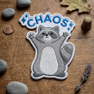 May include: A set of three ceramic mugs with a speckled, matte finish. The mugs are in shades of cream, light gray, and dark gray. Each mug has a simple, minimalist design and a rounded handle.