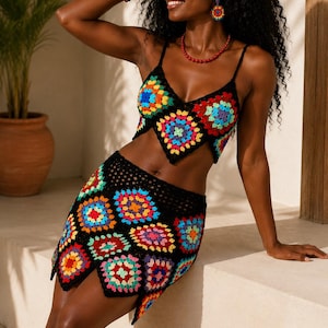 May include: A two-piece crochet set consisting of a black cropped camisole top and a matching mini skirt. Both pieces feature a vibrant granny square pattern in shades of red, yellow, blue, green, and purple, connected by black yarn borders.