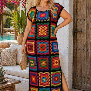 May include: A colorful, handmade crochet dress featuring a patchwork design with vibrant squares in shades of red, orange, yellow, green, blue, and purple. The dress has short sleeves and a maxi length with a side slit. The dress is worn outdoors.