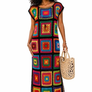 May include: A colorful, crochet maxi dress featuring a patchwork design with vibrant squares in shades of red, orange, yellow, green, blue, and purple. The dress has a black border and short sleeves. A woven tote bag is held in the hand.