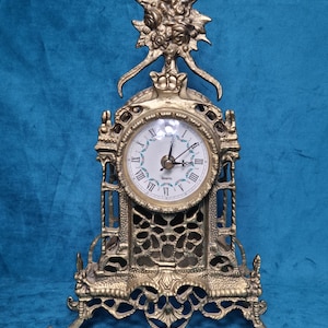 May include: A white ceramic mug with a black handle and the text "But First, Coffee" in a black, bold font. The mug is on a white surface.