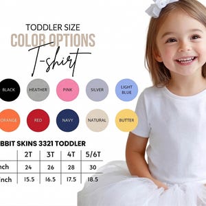 May include: A white toddler t-shirt with color options and size chart. The chart shows sizes 2T to 5/6T, with width measurements from 24 to 30 inches and lengths from 15.5 to 18.5 inches. Color options include white, black, and pink.
