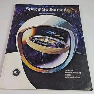 May include: A book titled "Space Settlements: A Design Study" with a colorful illustration of a space station. The cover features a starry background, a large circular structure, and the NASA logo. The book is a design study.