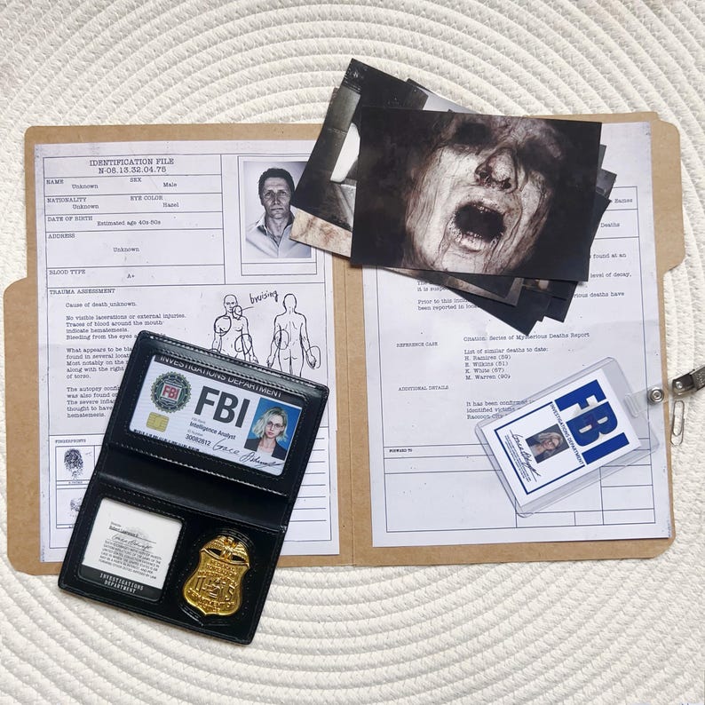 May include: A file folder with crime scene photos, an FBI badge, and an FBI ID card. The folder contains documents with text and illustrations. The FBI badge is gold and the ID card is in a clear plastic holder.
