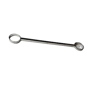 May include: A stainless steel bar with a ring on one end and a small, shallow bowl on the other. The bar is straight and the metal has a shiny finish. The tool is likely used for measuring or mixing ingredients.