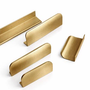 May include: A white ceramic mug with a black handle and the text "But First, Coffee" in a black, bold font. The mug is sitting on a wooden surface. The mug is 4 inches tall.