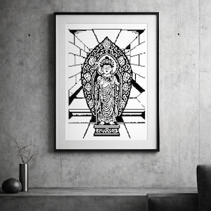 Puede incluir: Impresión enmarcada en blanco y negro de una estatua de Buda pixelada. La obra de arte presenta una representación detallada de la figura de pie dentro de un marco ovalado adornado, sobre un fondo de formas geométricas. La impresión se exhibe en una pared de hormigón gris.