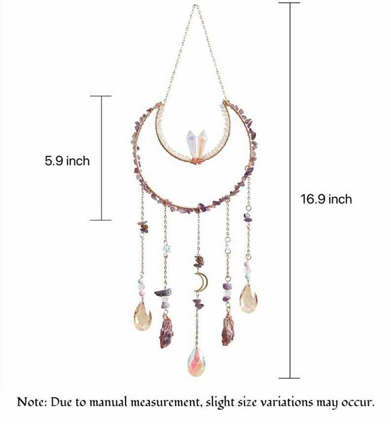 May include: A hanging wall ornament featuring a crescent moon frame adorned with purple stone chips, two clear crystals, and dangling chains with beads and teardrop-shaped pendants. The total height is 16.9 inches and the width is 5.9 inches.