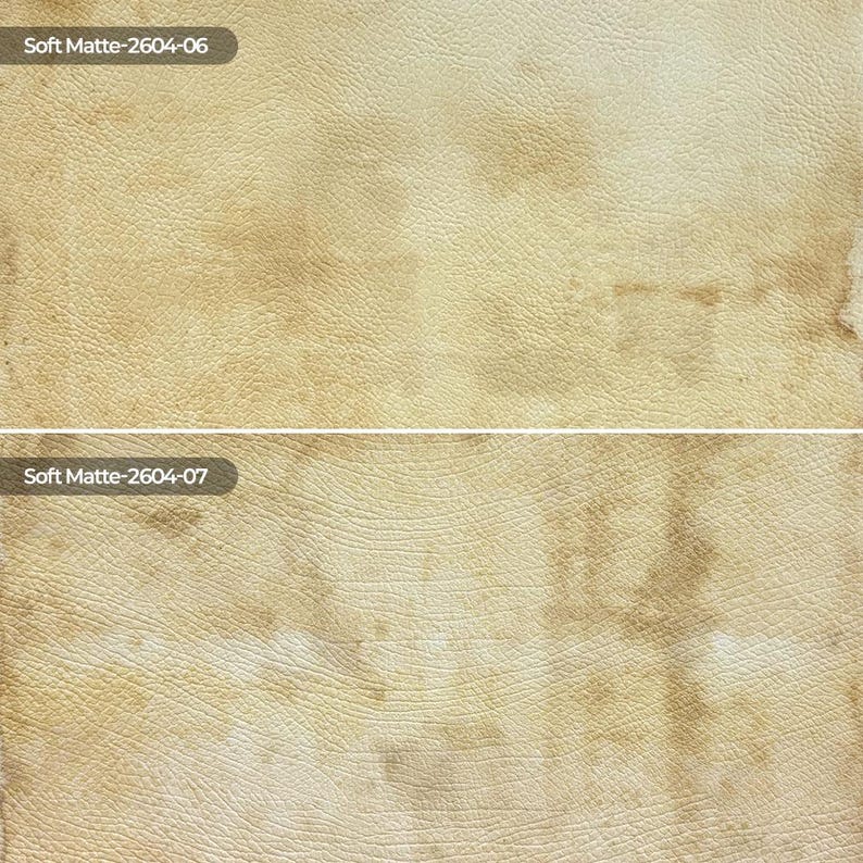 May include: A split-screen view of two textured surfaces with a beige and tan mottled pattern. The top section is labeled Soft Matte-2604-06 and the bottom section is labeled Soft Matte-2604-07, both displaying a leather-like grain appearance.