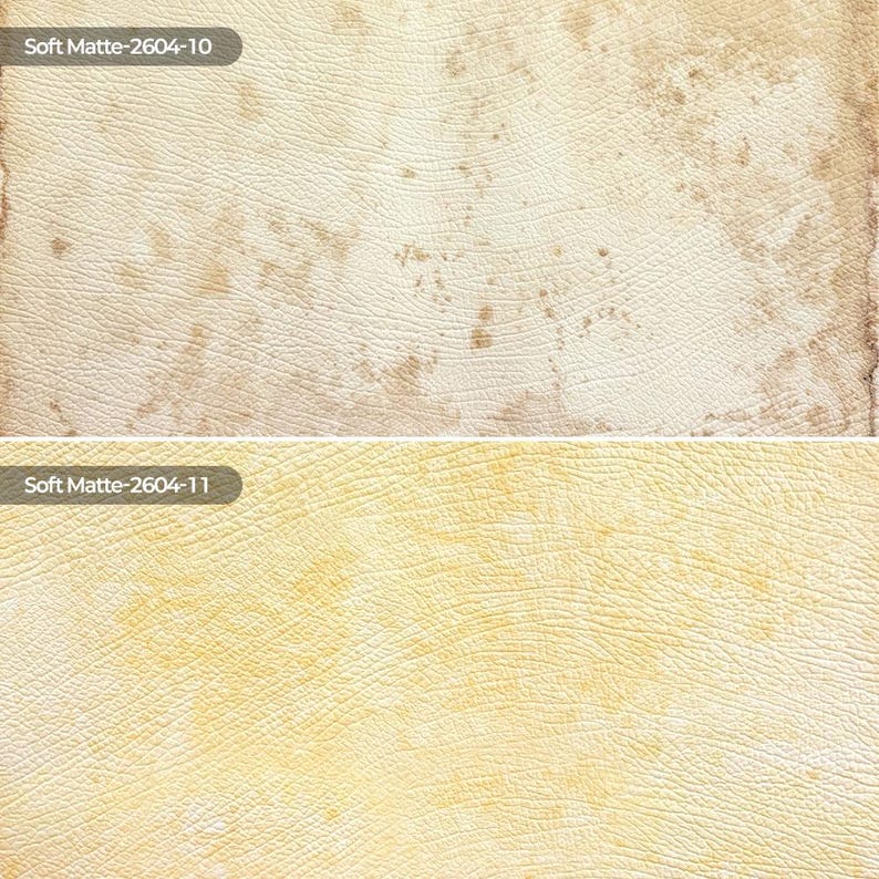 May include: Two rectangular swatches of textured material with a matte finish. The top swatch is off-white with brown mottled patches and the text Soft Matte-2604-10. The bottom swatch is pale yellow with light yellow patches and the text Soft Matte-2604-11.