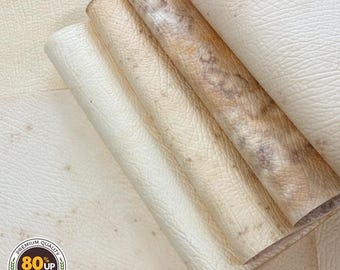 May include: Close-up of several rolled sheets of off-white and tan leather. The leather has a textured surface and varying shades of color. The image includes a circular logo with the text "Premium Quality 80% Up Biomass Guaranteed."
