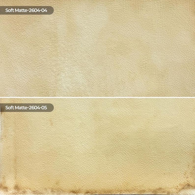 May include: Two rectangular swatches of beige textured material with a matte finish. The top swatch is labeled Soft Matte-2604-04, and the bottom swatch is labeled Soft Matte-2604-05, featuring a slightly darker, weathered edge at the bottom.