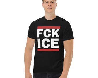 May include: Black t-shirt with the white text "FCK ICE" in a red rectangular box. The t-shirt is short-sleeved and made of a soft material. The person in the image is wearing dark blue jeans.