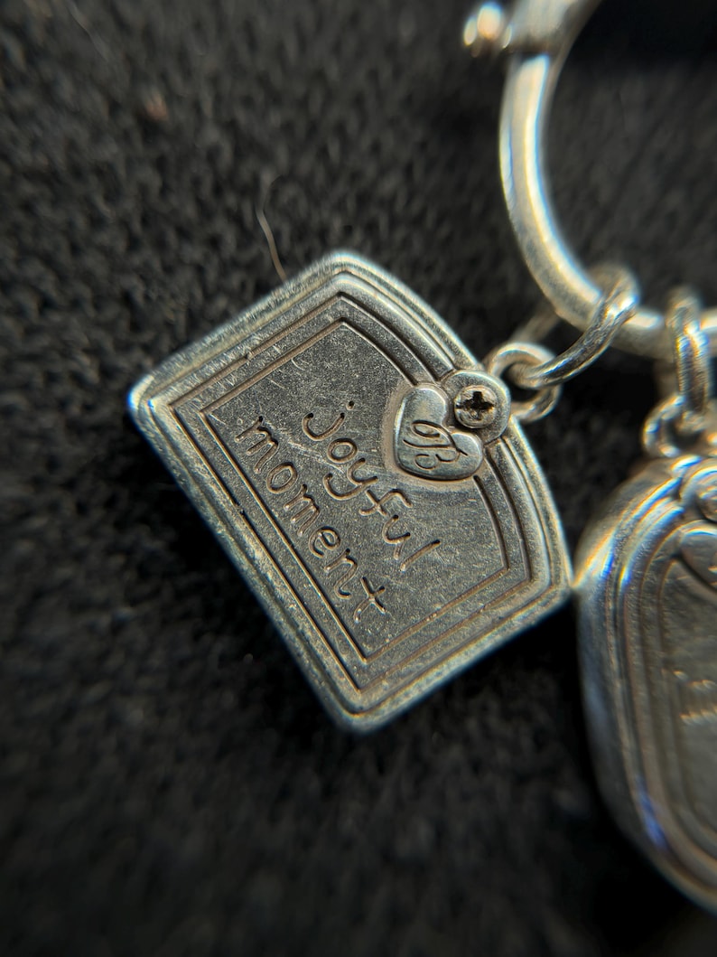 May include: A white ceramic mug with a black handle and the text "But First, Coffee" in a bold, black font. The mug is set against a blurred background, suggesting a cozy setting.