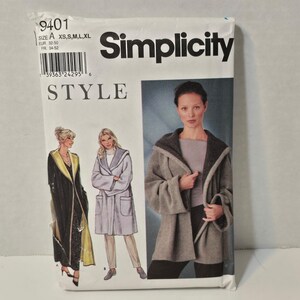 May include: Simplicity sewing pattern 9401. The pattern features illustrations of hooded coats and robes. The package includes size options XS, S, M, L, and XL. The word "STYLE" is printed below the Simplicity logo.