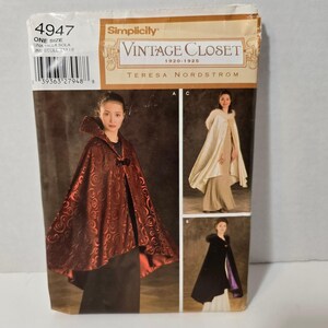 May include: Simplicity Vintage Closet sewing pattern 4947. The pattern features a cape design. The front of the pattern shows a woman wearing a red cape with a swirl pattern. The pattern includes the text "Vintage Closet 1920-1925".