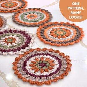 May include: A selection of handmade crochet coasters in various colours. Each coaster has a circular design with detailed patterns in orange, brown, green, white, and burgundy. The image includes the text "ONE PATTERN, MANY LOOKS!"