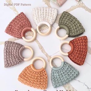 May include: Seven crochet towel holders arranged in a circle, each featuring a wooden ring and a textured fabric piece in various colours including cream, olive green, rust, light blue, peach, mauve, and dusty rose. Text reads Digital PDF Pattern.