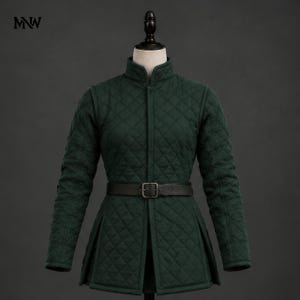May include: A dark green quilted jacket featuring a high collar, long sleeves, and a black leather belt with a metal buckle at the waist. The garment has a diamond-stitched pattern throughout and the letters MNW are printed in the top left corner.