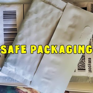 May include: Image of packaging materials, including white padded envelopes and shipping labels. The text "SAFE PACKAGING" is displayed in yellow letters. Barcodes and shipping details are visible.