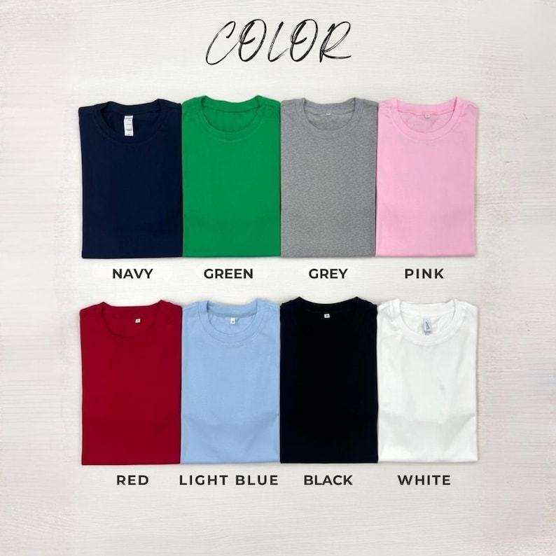 May include: Folded t-shirts in a range of colours: navy, green, grey, pink, red, light blue, black, and white. The word "COLOR" is written in cursive at the top of the image.
