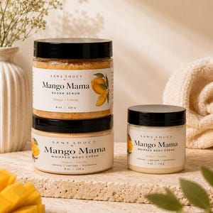 以下が含まれることがあります： Sans Soucy Mango Mamaのシュガースクラブとホイップボディクリームの重ねられた瓶2つと、ホイップボディクリームの小さな瓶1つ。ラベルにはマンゴーのイラストと、正味重量226gおよび113gの表記が記載されています。