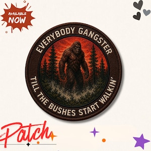 May include: A circular embroidered patch featuring a brown Bigfoot creature standing in a forest with a red sunset background. The text "EVERYBODY GANGSTER TILL THE BUSHES START WALKIN'" is stitched in a circular border around the central graphic image.