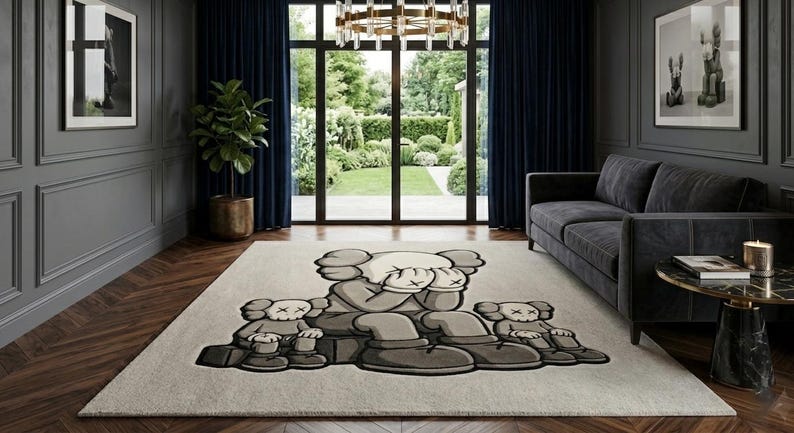 K&ouml;nnte beinhalten: Rechteckiger Teppich mit einem Cartoon-Charakter-Design in Grau- und Beiget&ouml;nen. Der Teppich befindet sich in einem Wohnzimmer mit einem dunkelgrauen Sofa, einem runden Beistelltisch und einem gro&szlig;en Fenster.