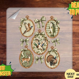 May include: A DTF transfer sheet featuring five oval frames with rustic wood-look borders. The frames contain illustrations of a pheasant, a bass, a mallard duck, a deer, and a turkey, each accented with green and white patterned bows.