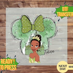 May include: DTF transfer featuring Princess Tiana in a green and white design. The design includes a green bow with white polka dots, a castle, and the name "Tiana". The words "Ready to Press" and "DTF Transfer" are also visible.