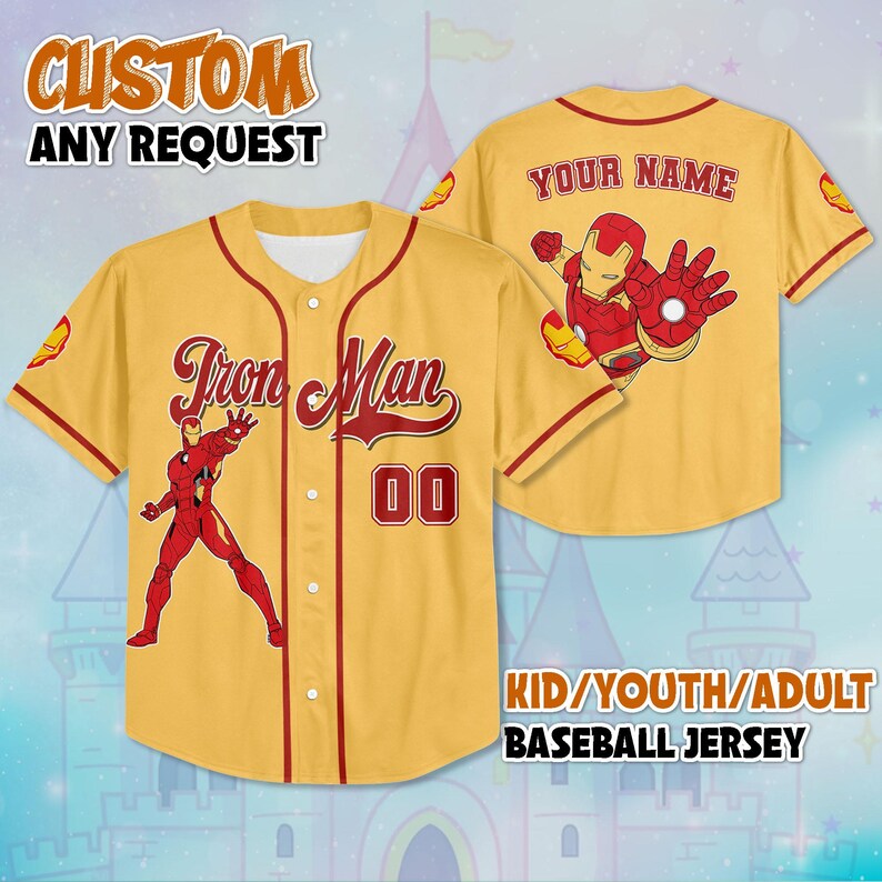 May include: A yellow baseball jersey with red trim, featuring the words "Iron Man" and the number "00". The front displays an Iron Man graphic. The back has an Iron Man graphic and the words "YOUR NAME". The jersey is available for kids, youth, and adults.