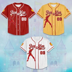 May include: Three baseball jerseys featuring the Iron Man character. The jerseys are red, yellow, and white, each with the Iron Man logo on the sleeve and the words "Iron Man" across the chest. Each jersey has the number "00" on the front.