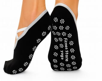 May include: Black yoga socks with white floral patterns and a white strap. The socks have a gray trim and the text "Fitness Store yoga" printed on the sole. These socks are designed for yoga and Pilates.