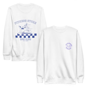 May include: Two white sweatshirts. One features a blue graphic of a running cartoon character on a treadmill with the text "FITNESS STORE RUN CLUB EST 2025". The other has a small blue circular logo that says "FITNESS STORE" with smiley faces.