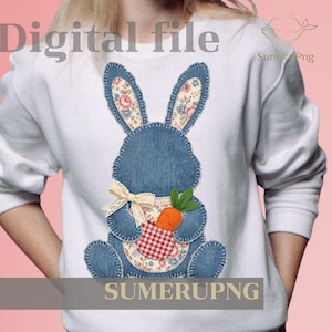 May include: White sweatshirt featuring a denim-style bunny applique with floral-patterned ears and belly. The bunny holds a carrot and is adorned with a cream-colored bow. The words "Digital file" and "SUMERUPNG" are visible.
