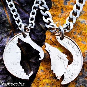 May include: Two silver necklaces featuring a wolf silhouette cut out of a US quarter coin. The necklaces are displayed against a brown and purple background.