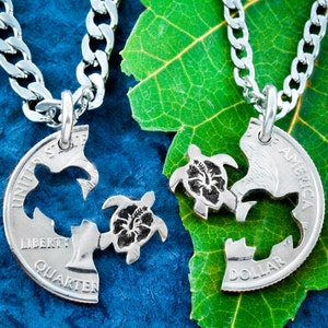 May include: Two silver necklaces with matching turtle pendants. The pendants are made from US quarters and are cut to form two halves of a turtle. Each turtle has a hibiscus flower on its back.