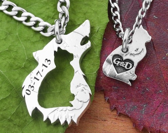 May include: Two silver necklaces with matching pendants. One pendant is a wolf with a cat cutout and the date 03-17-13 engraved on it. The other pendant is a cat with a heart and the initials G&D engraved on it.