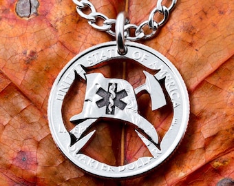 May include: Silver quarter dollar coin necklace with a cut-out design of a firefighter's helmet and axe. The coin is on a chain and has the words "United States of America" and "Quarter Dollar" inscribed on it.
