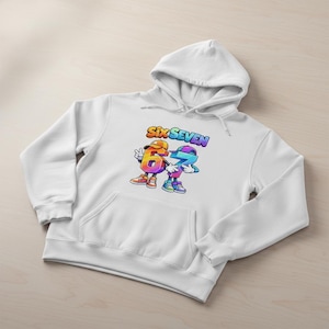 May include: White hoodie with a front pocket and a drawstring hood. The graphic on the front features the words "SIX SEVEN" above two cartoon numbers, six and seven, in vibrant colors. The numbers are wearing hats and shoes.