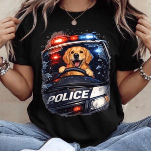 May include: Black t-shirt with a cartoon image of a Golden Retriever dog driving a police car. The dog is smiling, and the car has flashing lights and the word "POLICE" on the front.