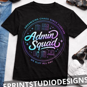 May include: Black t-shirt with a circular design featuring the words "Admin Squad" in a gradient of blue and purple. The design includes office-related icons and the phrases "Organizing Chaos Since Forever" and "We Slay All Day."